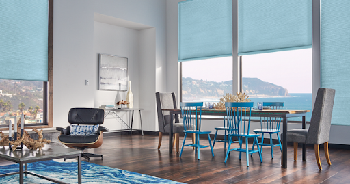 Blue cellular shade treatments in modern dining room with ocean view