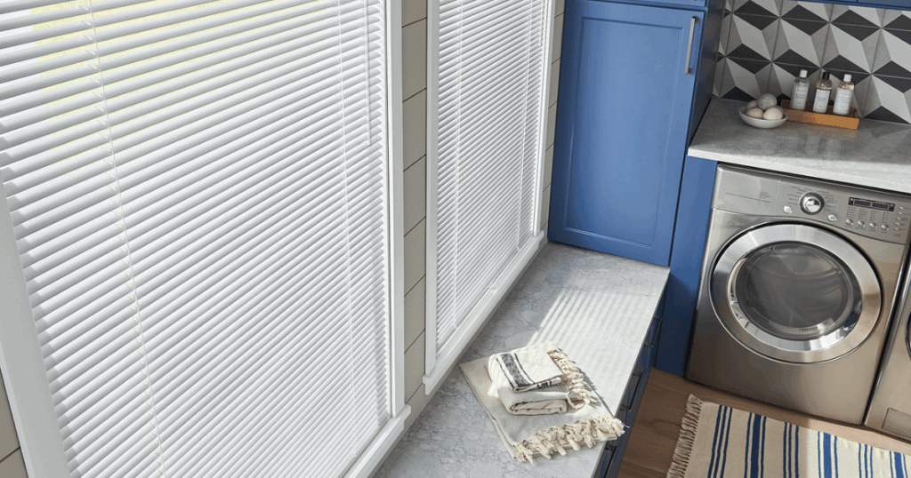 Laundry room with natural light filtering through white blinds – tip for maximizing daylight in utility spaces
