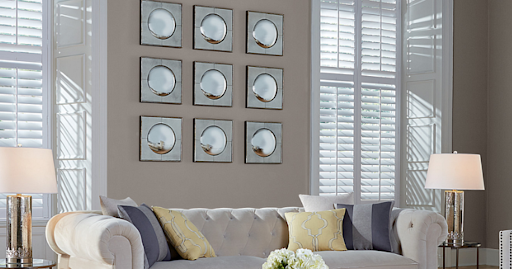 5 Simple Tips to Keep Your Blinds Looking Brand New 1 Elegant living room featuring white plantation shutters and tufted beige couch Tips & Tricks