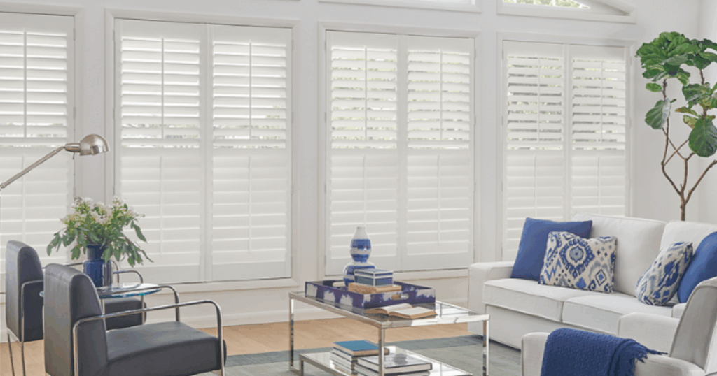 Living room with white plantation shutters showcasing custom window treatments that increase home value in Kansas City.