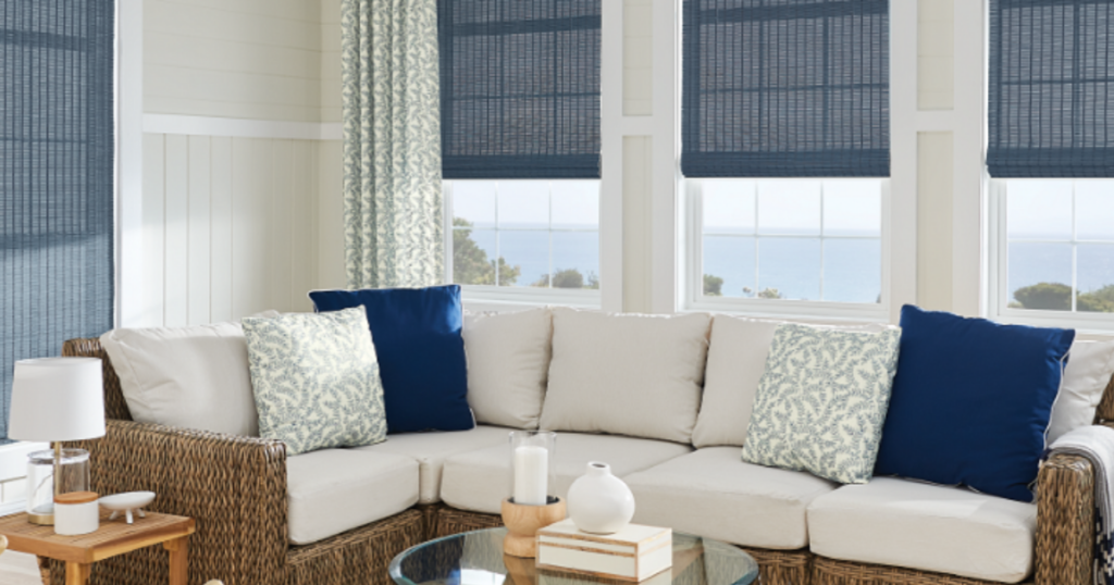 Light filtering woven wood shades in a bright living room with coastal decor, providing soft daylight and daytime privacy