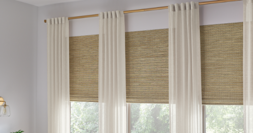 Window Treatments with layered Roman shades and floor-length drapes in a modern living room